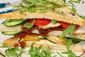 Sandwich with grilled chicken, fresh cucumber, tomato, arugula a, a Holiday Photo by ndanko