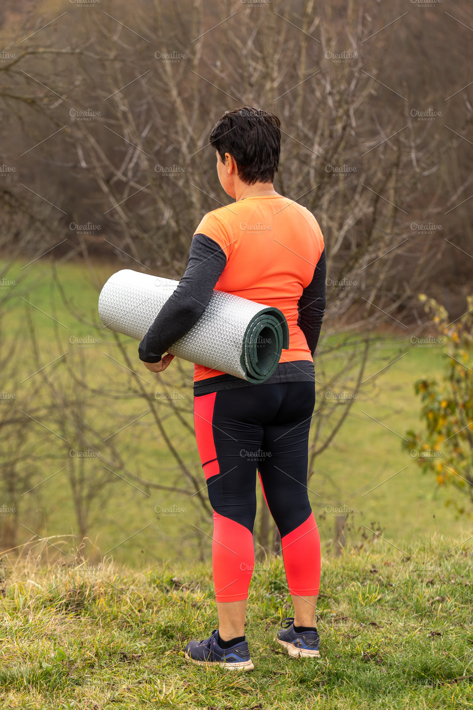 Woman carrying a yoga mat, a Photo by Grafvision photography