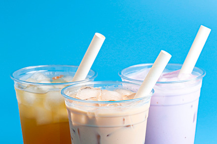 Three Different Types of Boba Tea on a Bright Blue Background