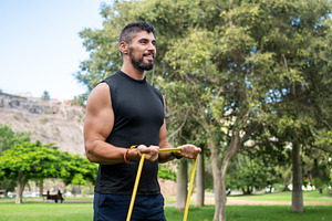 Athletic Man Doing Resistance Band Bicep Curls, a Sports & Recreation Photo by etorres69