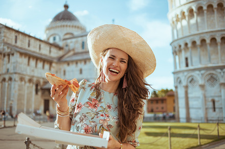 smiling elegant woman in floral dress with pizza and hat, a Person Photo by Alliance Images