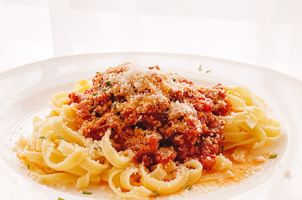 Pasta with bolognese sauce and parmesan cheese, homemade food an, a Food & Drink Photo by Anneleven