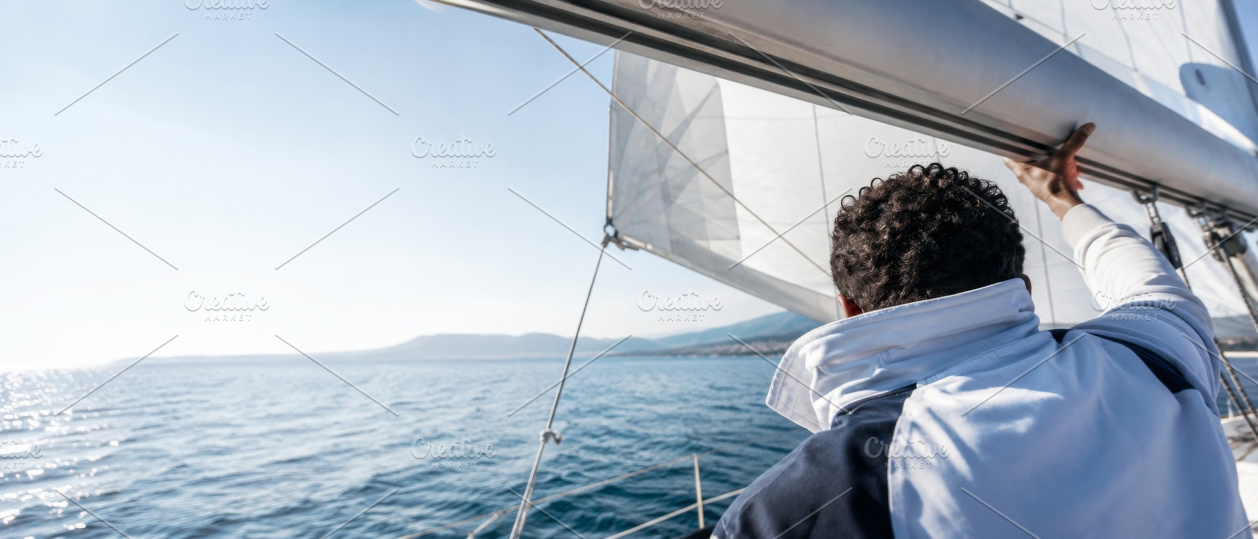 Sailor yachting in open sea with cle, a Photo by Dvoevnore photos