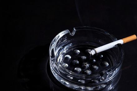 Ashtray and smoking cigarette on bla, a Health & Medical Photo by AlexBush