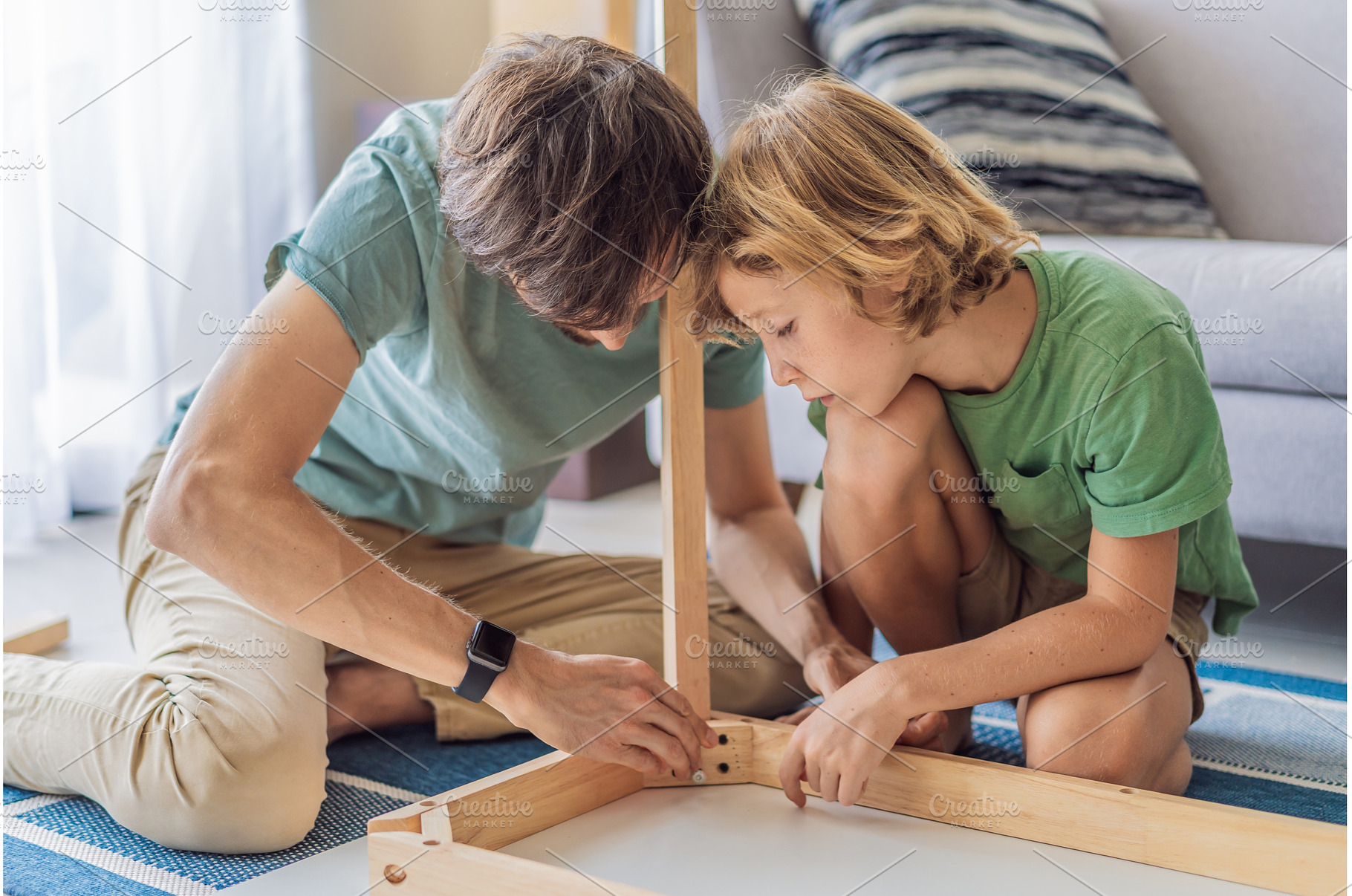 Father and his son assembling a, a Person Photo by Elizaveta Galitskaya