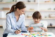Professional woman specialist training with cute little boy, showing him oral e, a Photo by Prostock-Studio (Thumbnail 2 of 2)