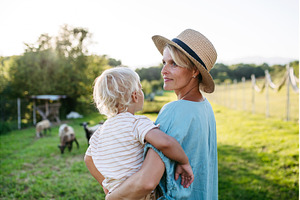 Mom and kid looking at animals at, an Animal Photo by HalfPoint