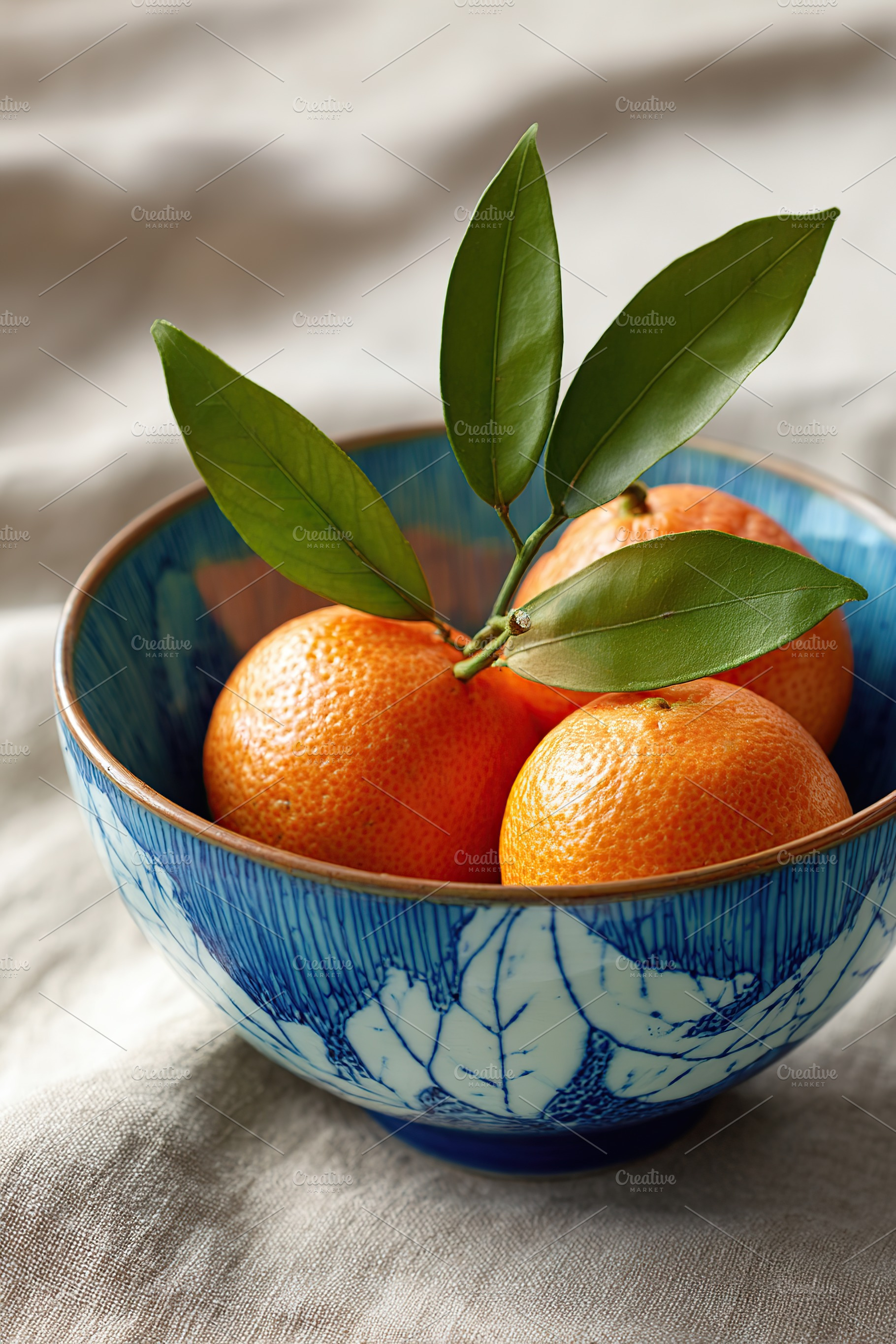 Handcrafted ceramic bowl filled with oranges and fresh leaves in a soft natural, a Food & Drink Photo by AlyaAnd