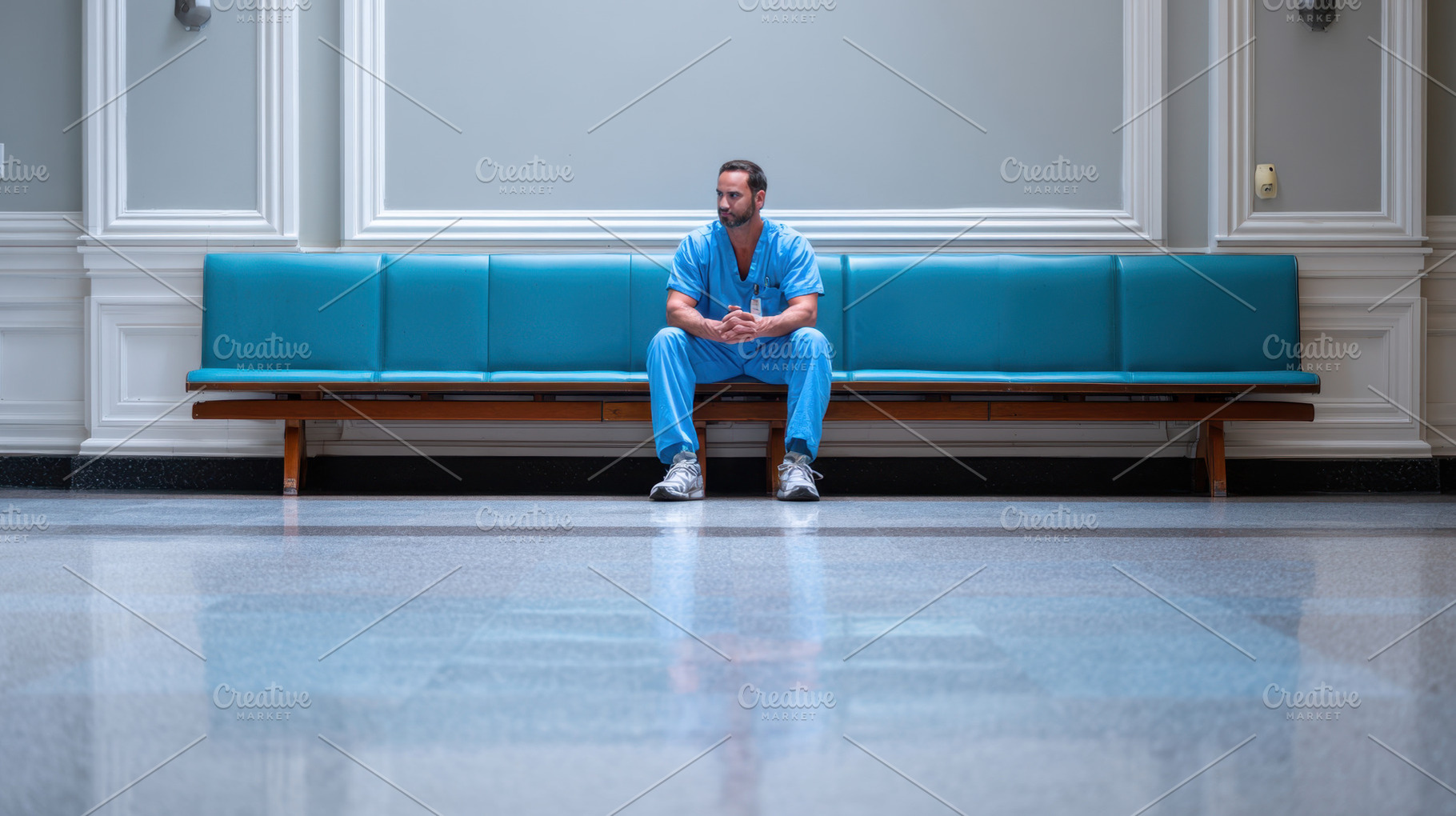 Man sits alone in hospital hallway, a Photo by Beautiful things