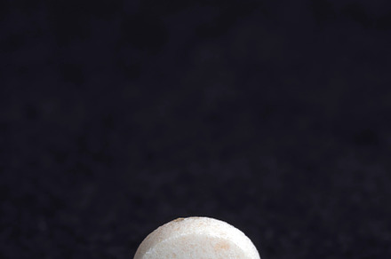 White and yellow medical medicines on a black background, a Background Photo by MyPhotos