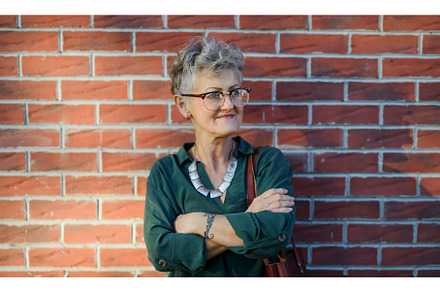 Senior woman standing outdoors, a Nature Photo by HalfPoint