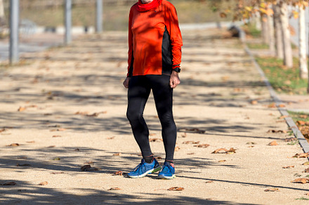 Senior man walking outdoors on a sunny autumn day