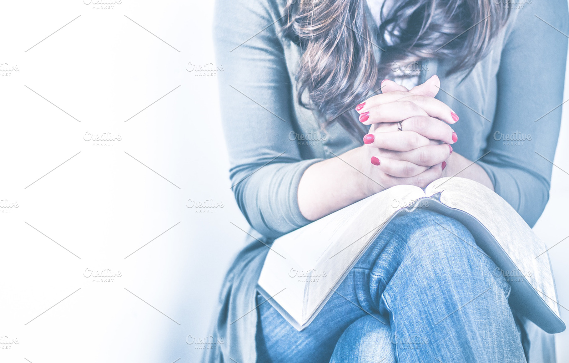 Women praying with open Bible, a Person Photo by Mission Media
