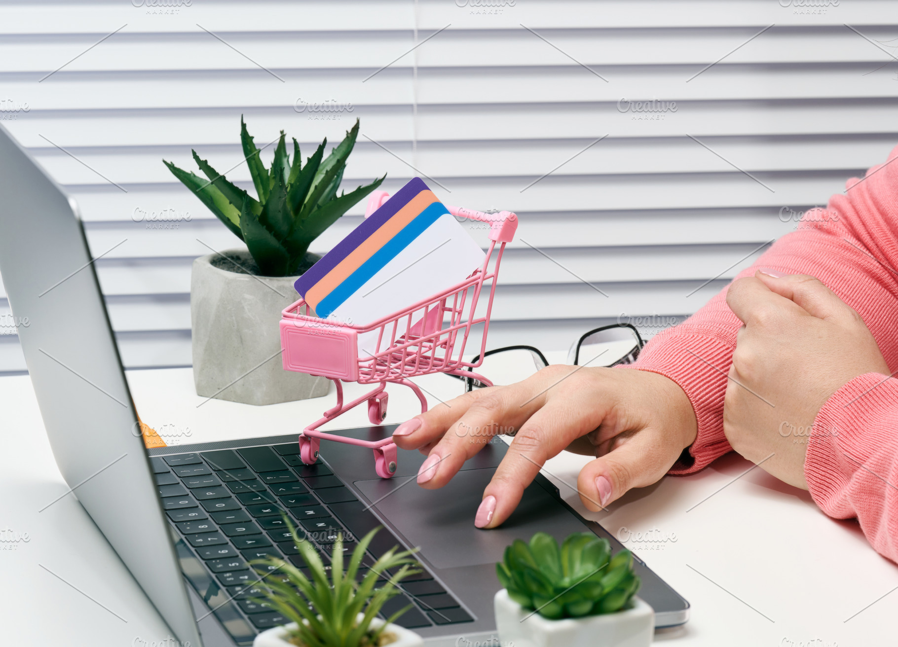 woman in a pink sweater makes purchases online with a laptop, a, a Business Photo by ndanko