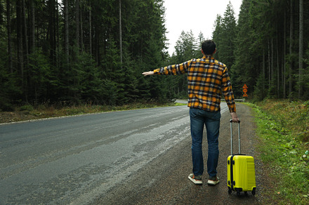 Adventure and tourism concept, young man traveling by auto stop, a Nature Photo by AtlasStudio PRO