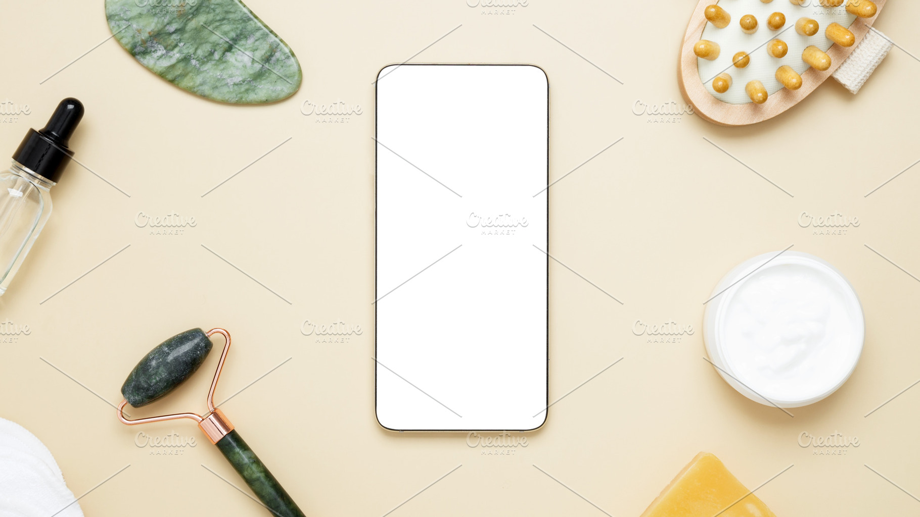 Smartphone display showcasing skincare products arranged with marble face rolle, a Photo by matucha