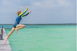 Boy jumping off a pier into a, a Nature Photo by Elizaveta Galitskaya