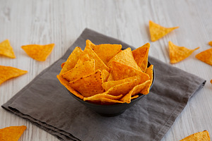 Crunchy Nacho BBQ Tortilla Chips in a Bowl, side view., a Food & Drink Photo by LiudmylaChuhunova