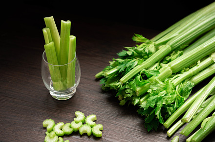 Bunch of fresh celery stalk on wooden table with leaves prepared, a Food & Drink Photo by Ministocker