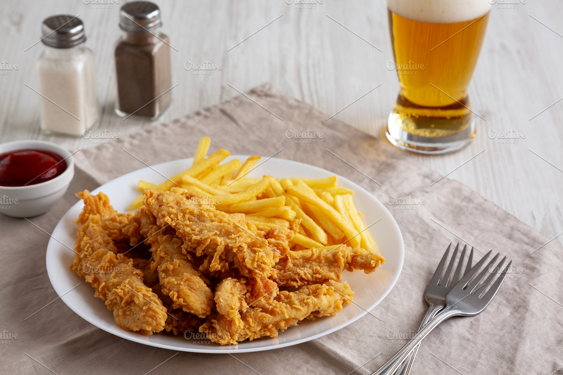 Homemade Chicken Strips with Fries on a Plate, side view., a Food & Drink Photo by LiudmylaChuhunova