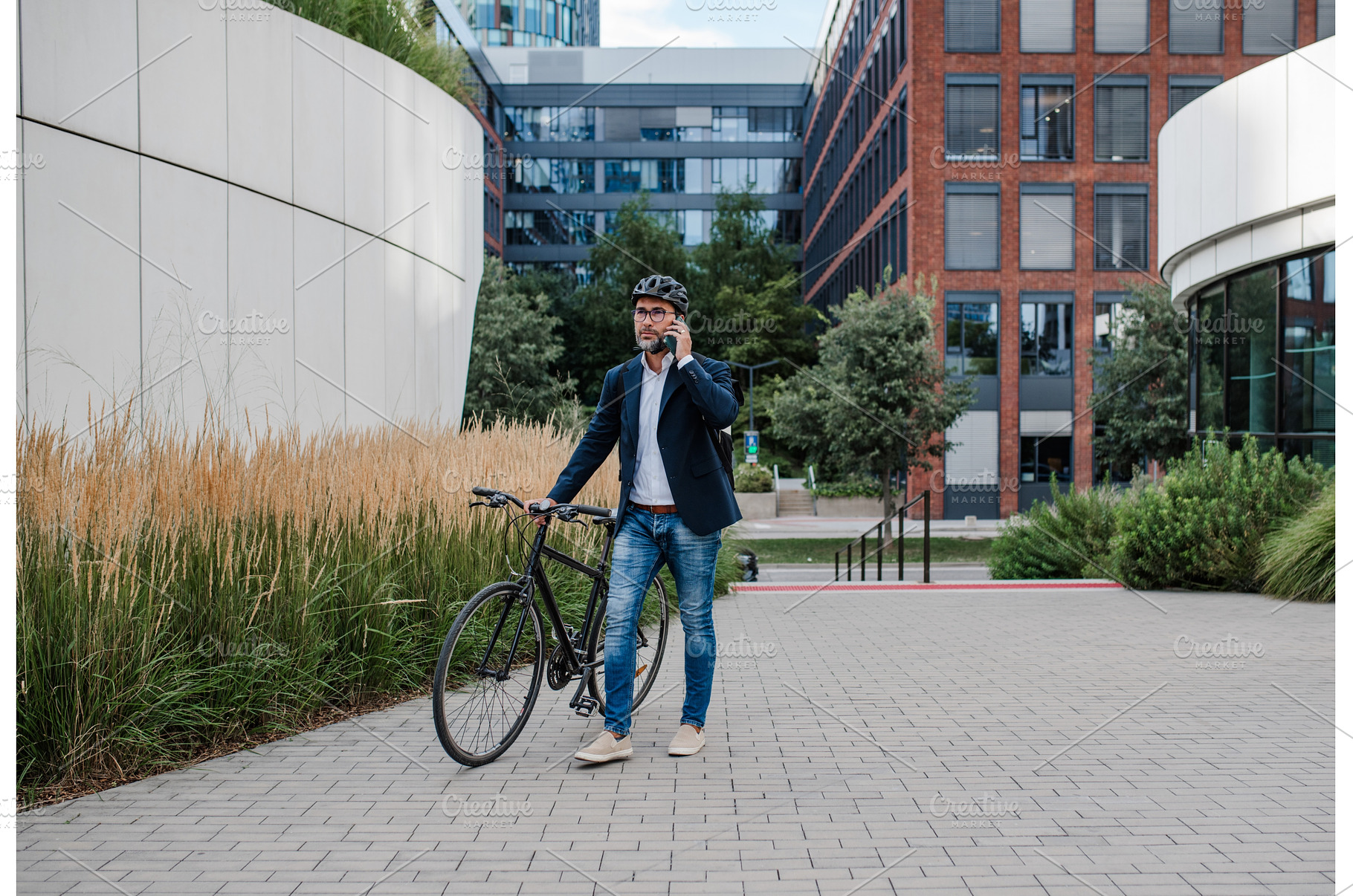 Male cyclist making phone call, a Person Photo by HalfPoint