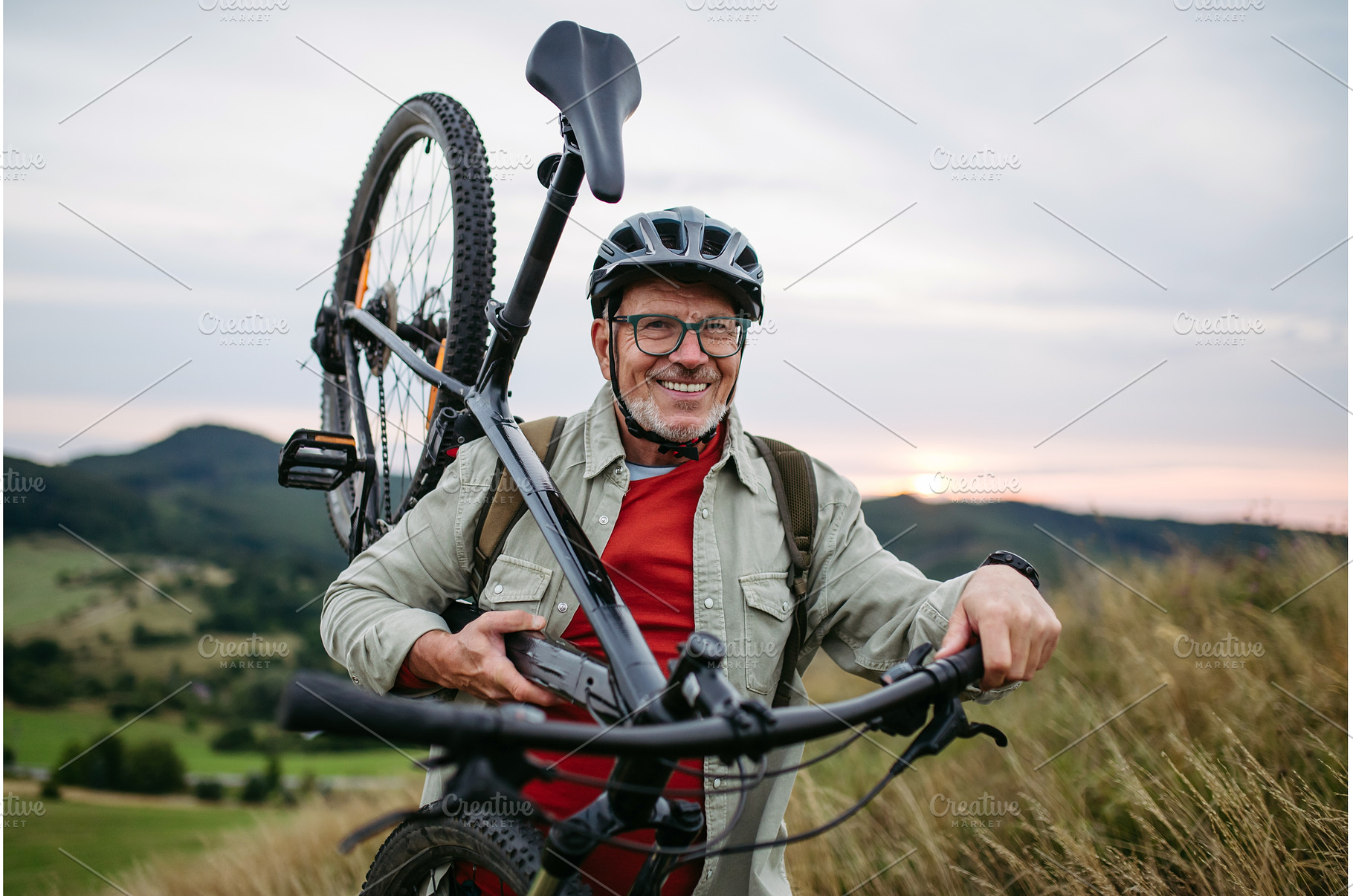 Smiling senior cyclist carrying, a Sports & Recreation Photo by HalfPoint