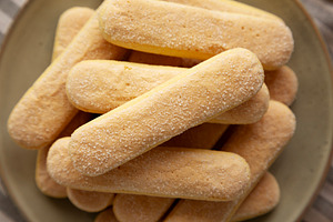 Savoiardi biscuits on a plate, top view. Close-up., a Food & Drink Photo by LiudmylaChuhunova