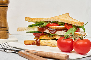 A layered sandwich with chicken, fresh cucumber, tomato and arug, a Food & Drink Photo by ndanko