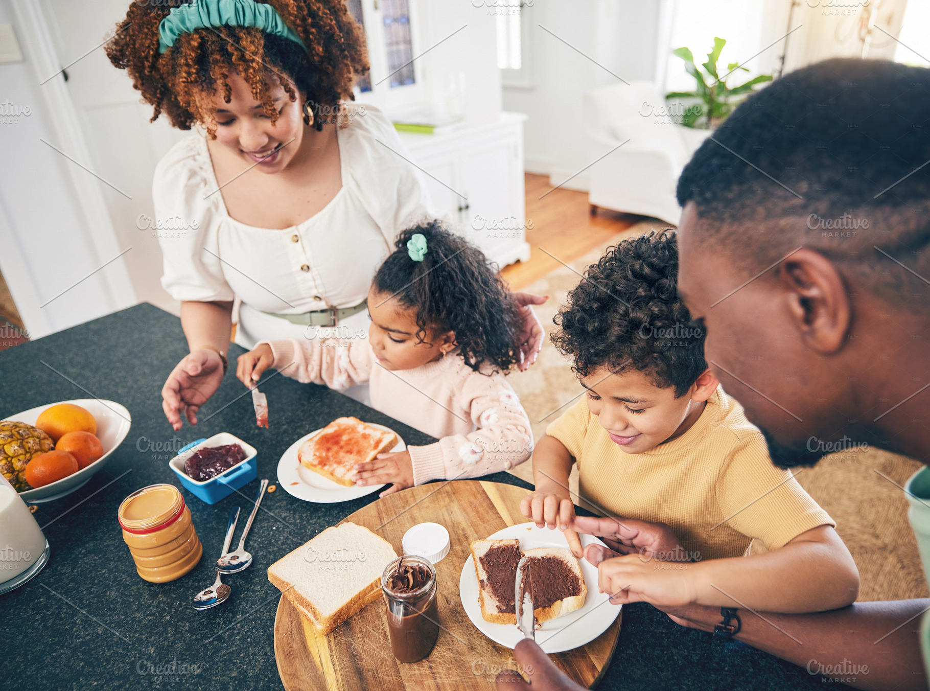 Love, lunch food and black family children, mother and father eating meal, bonding and prepare ingredients. Morning breakfast, kitchen counter or hungry mom, dad and young youth kids excited at home, a Photo by Peopleimages.com