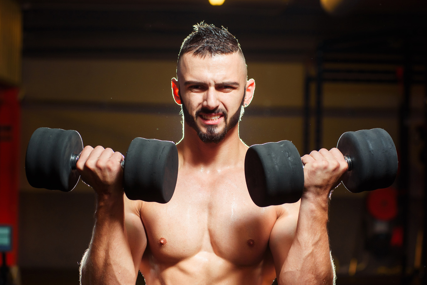 Muscular shirtless young man holding dumbbells in gym | Sports ...