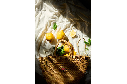 Bright summer lemons in a woven bag