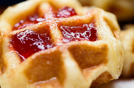 Close up fresh waffles with above strawberry jam