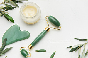 Gua sha stone, face roller and cream promoting skin care and rel, a Health & Medical Photo by Olena Rudo