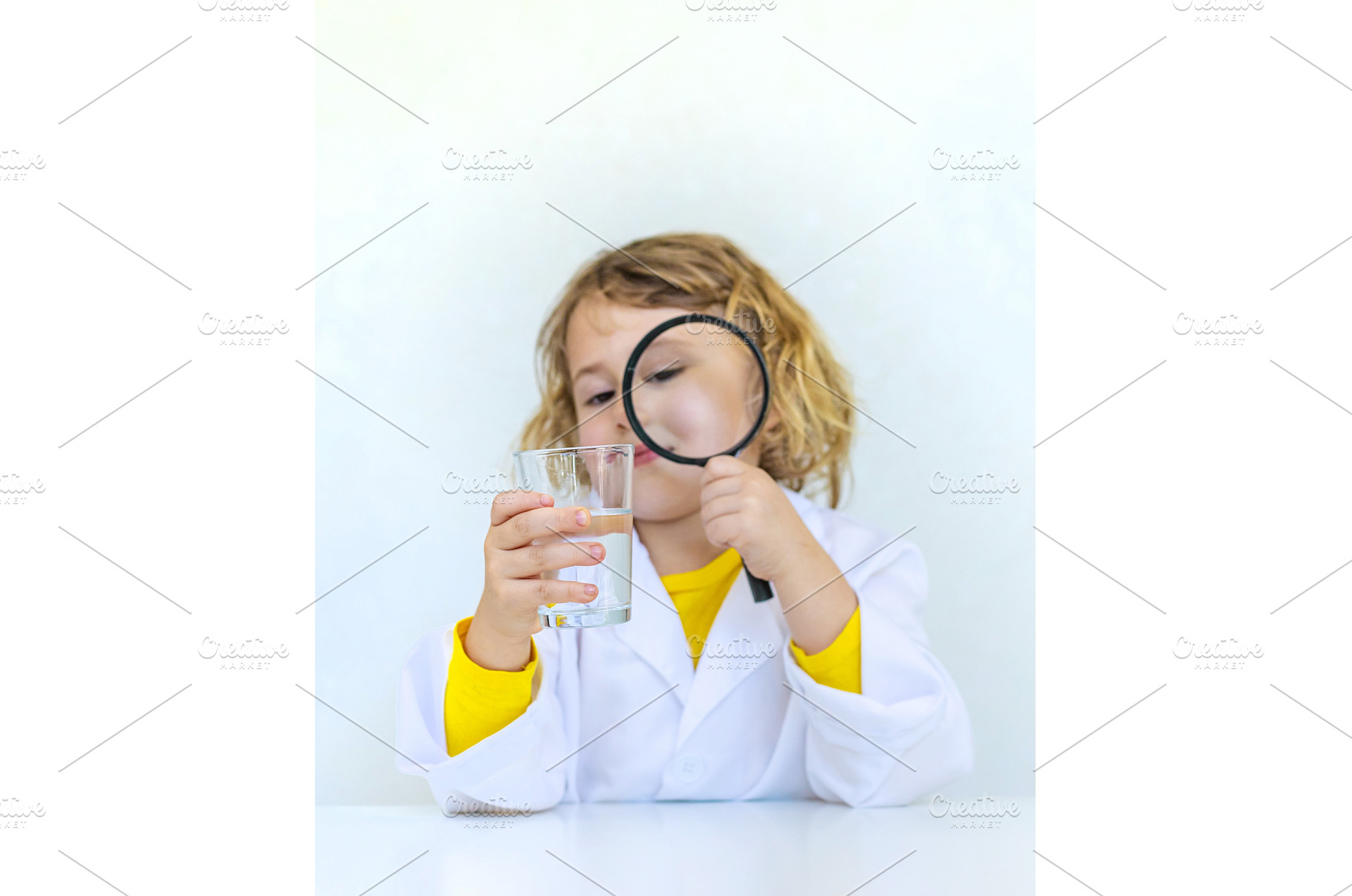 A child examines water with a, a School & Education Photo by yanadjana