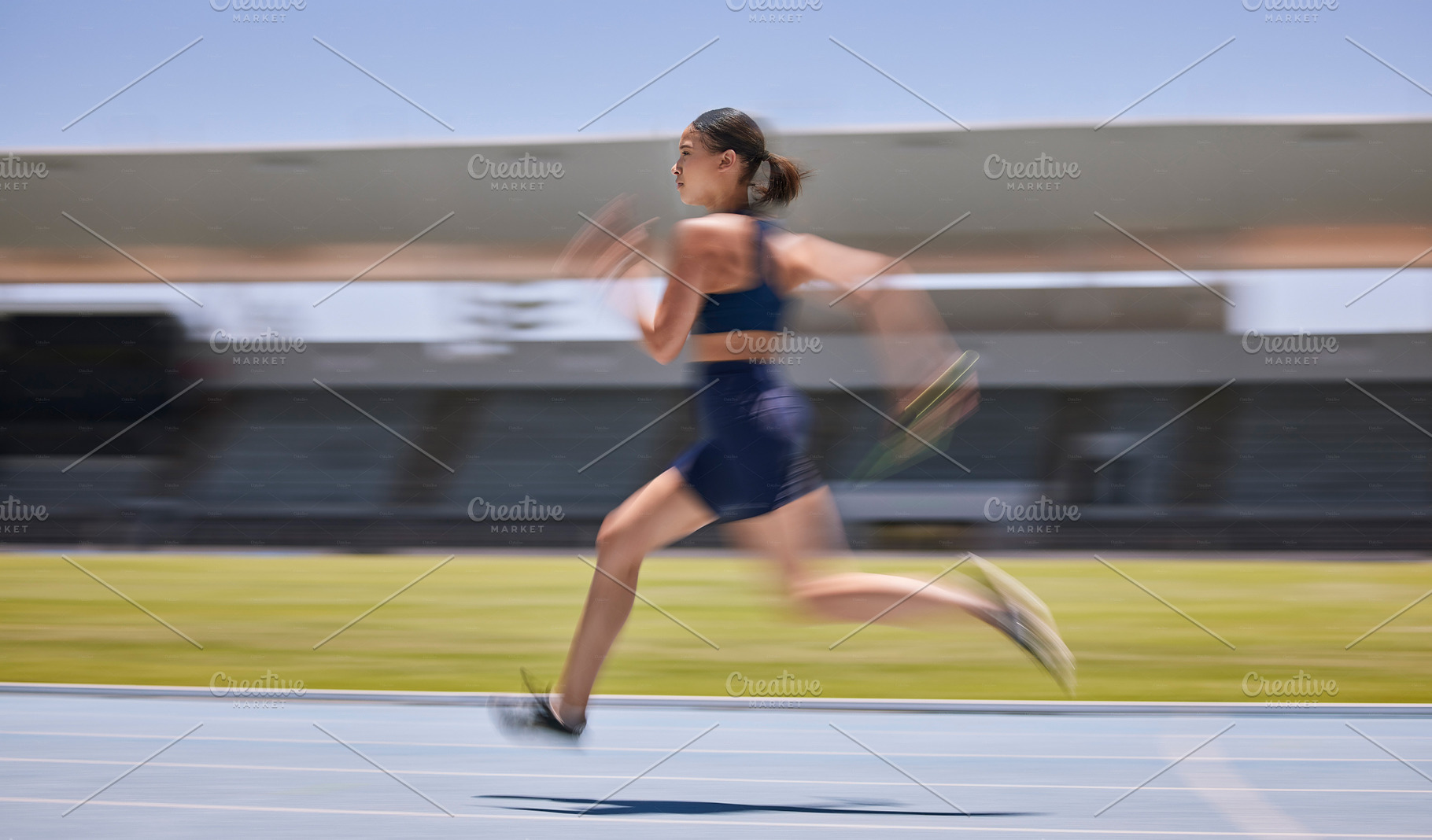 Woman, motion blur or running on stadium track in fitness training, workout or exercise for race, marathon or competition challenge. Runner, sports athlete or fast movement and speed in energy cardio, a Photo by Peopleimages.com