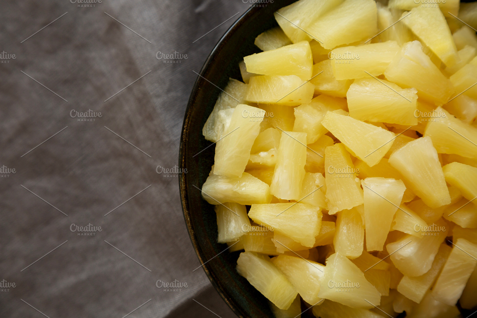 Canned Pineapple Tidbit Chunks in a Bowl, top view. Copy space., a Food & Drink Photo by LiudmylaChuhunova
