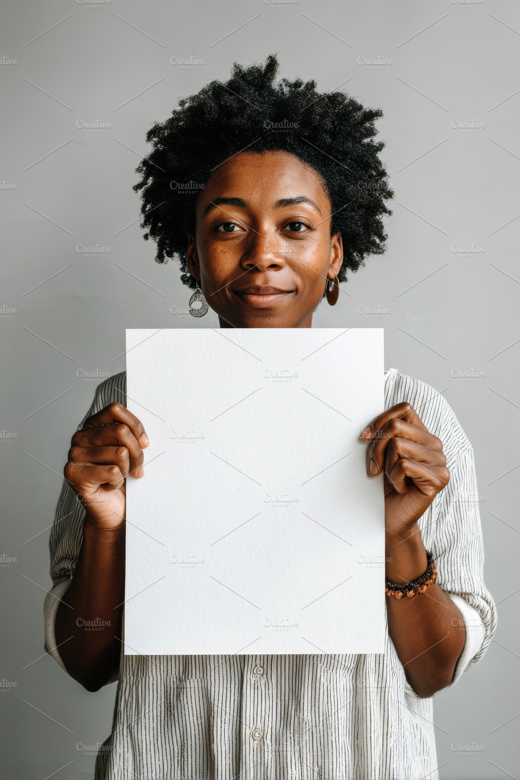 Woman holding white paper in soft lighting, a Person Photo by AlyaAnd