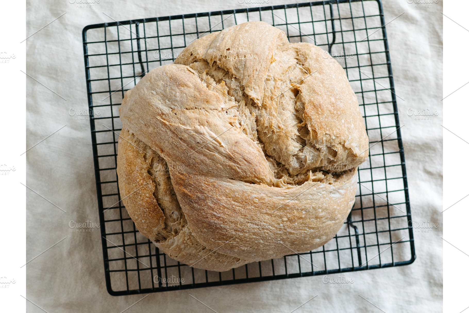 Sourdough knot bread cooling on wire, a Background Photo by Fascinadora