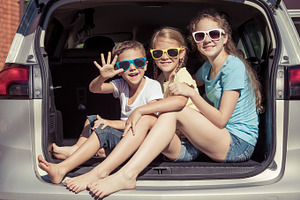 Happy kids sitting in the car featuring car, child, and family