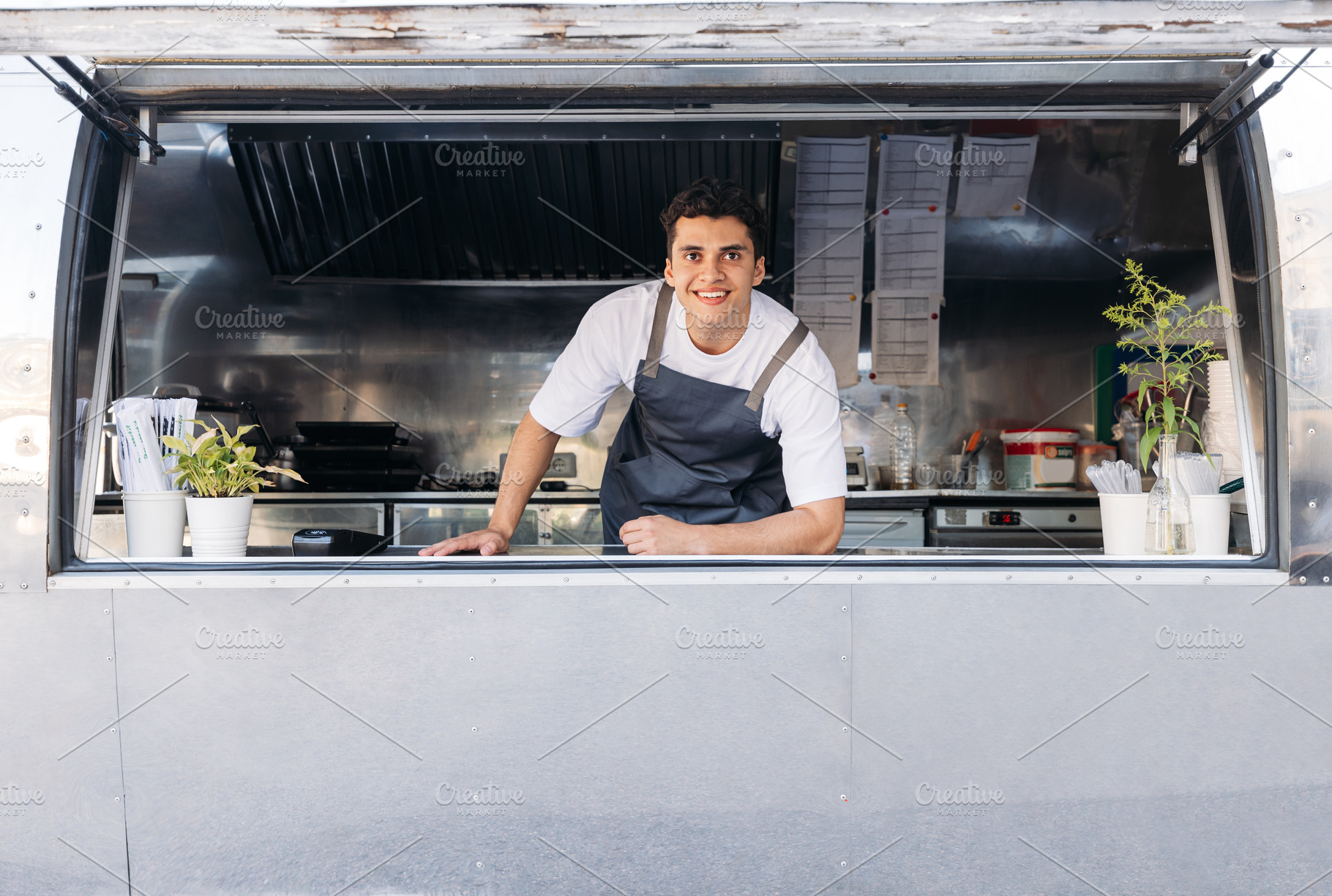 Food truck owner smiling, a Business Photo by Artem Varnitsin