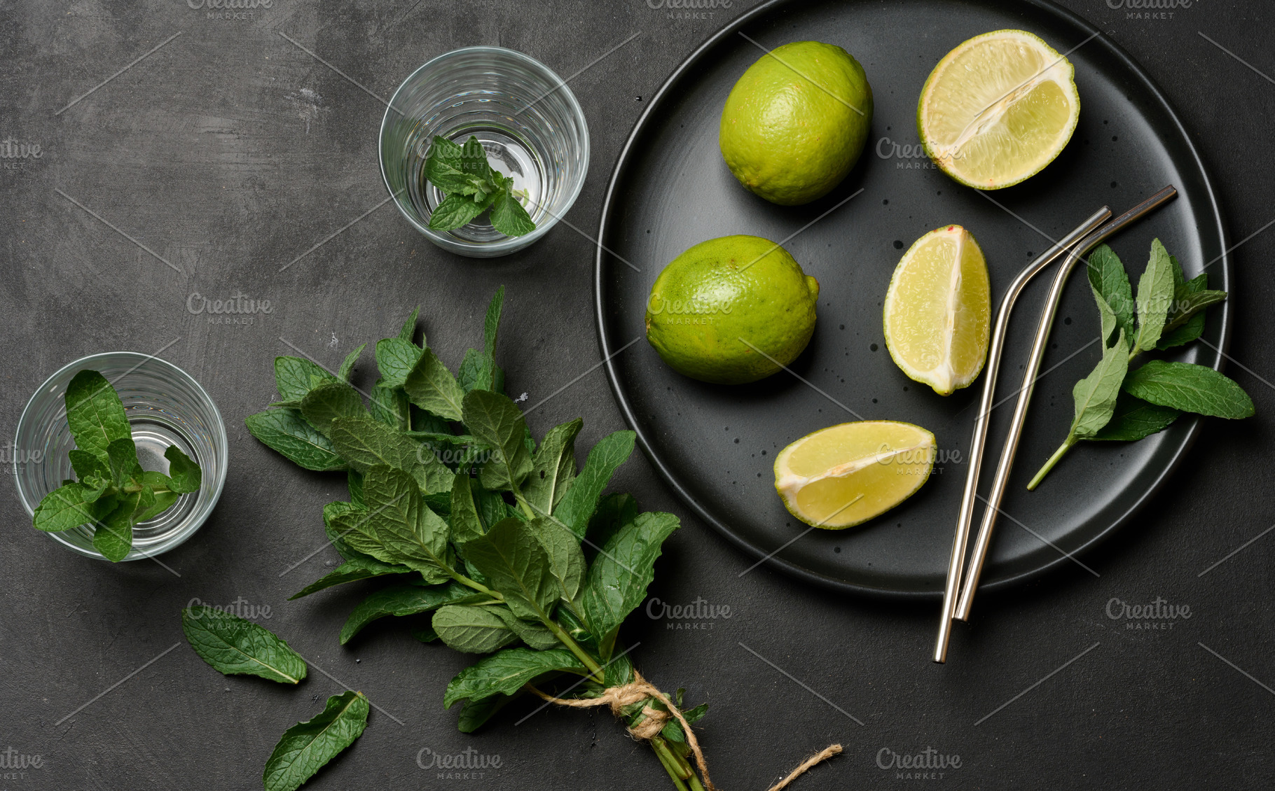 Bunch of fresh green mint, lime slices, glasses, top view. Cockt, a Food & Drink Photo by ndanko