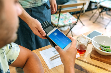 Customer paying the restaurant bill with a virtual mobile card, a Person Photo by davidpereiras