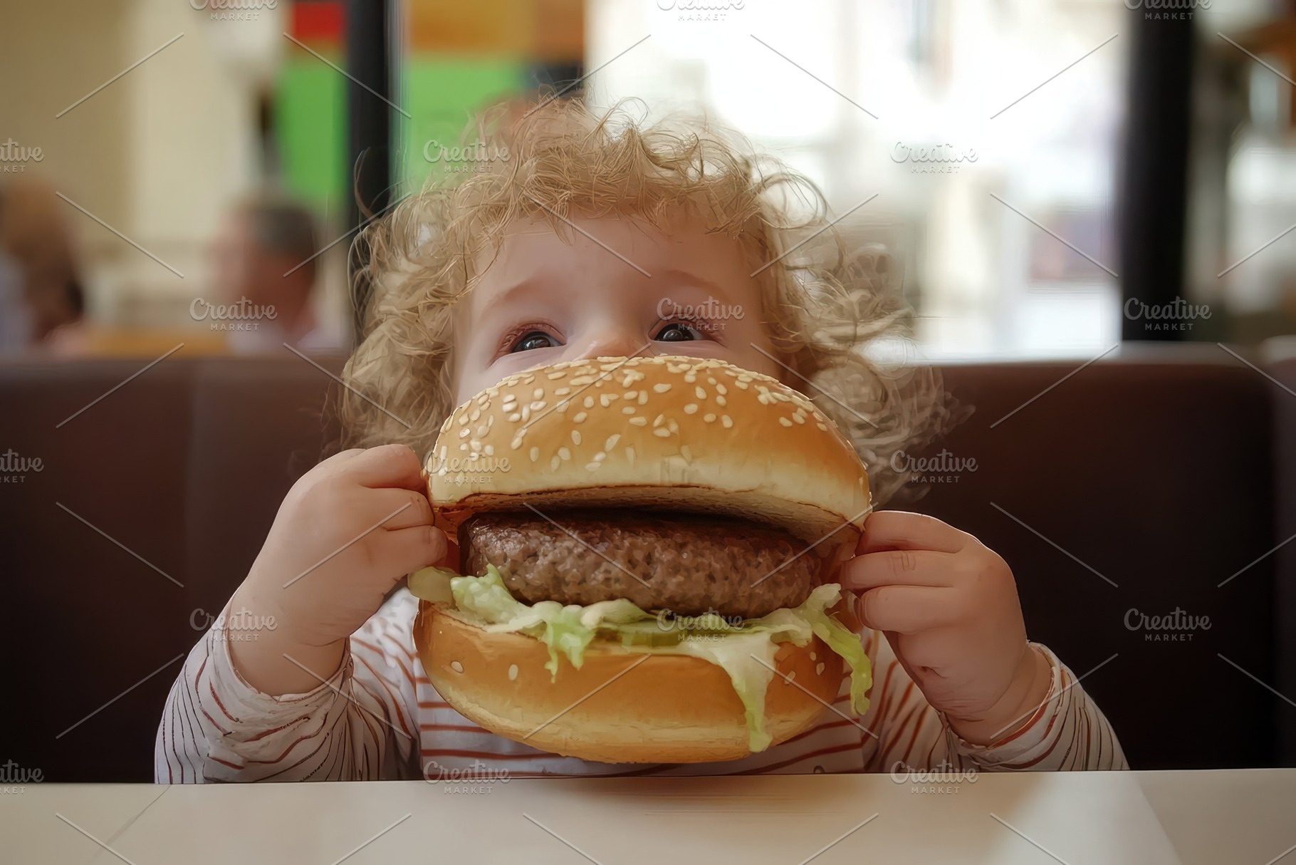Boy enjoys oversized burger in busy, a Photo by Iftikhar Alam