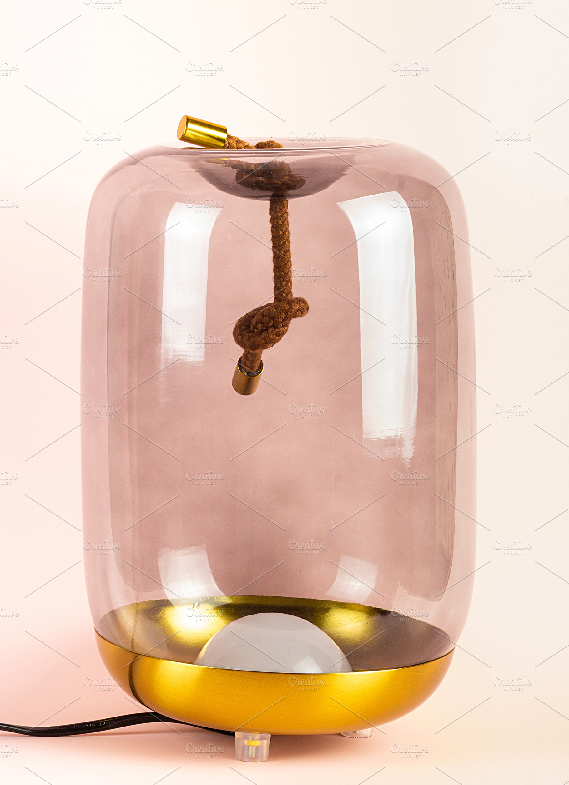 A glowing lamp on a pink background, a Technology Photo by AlexBush