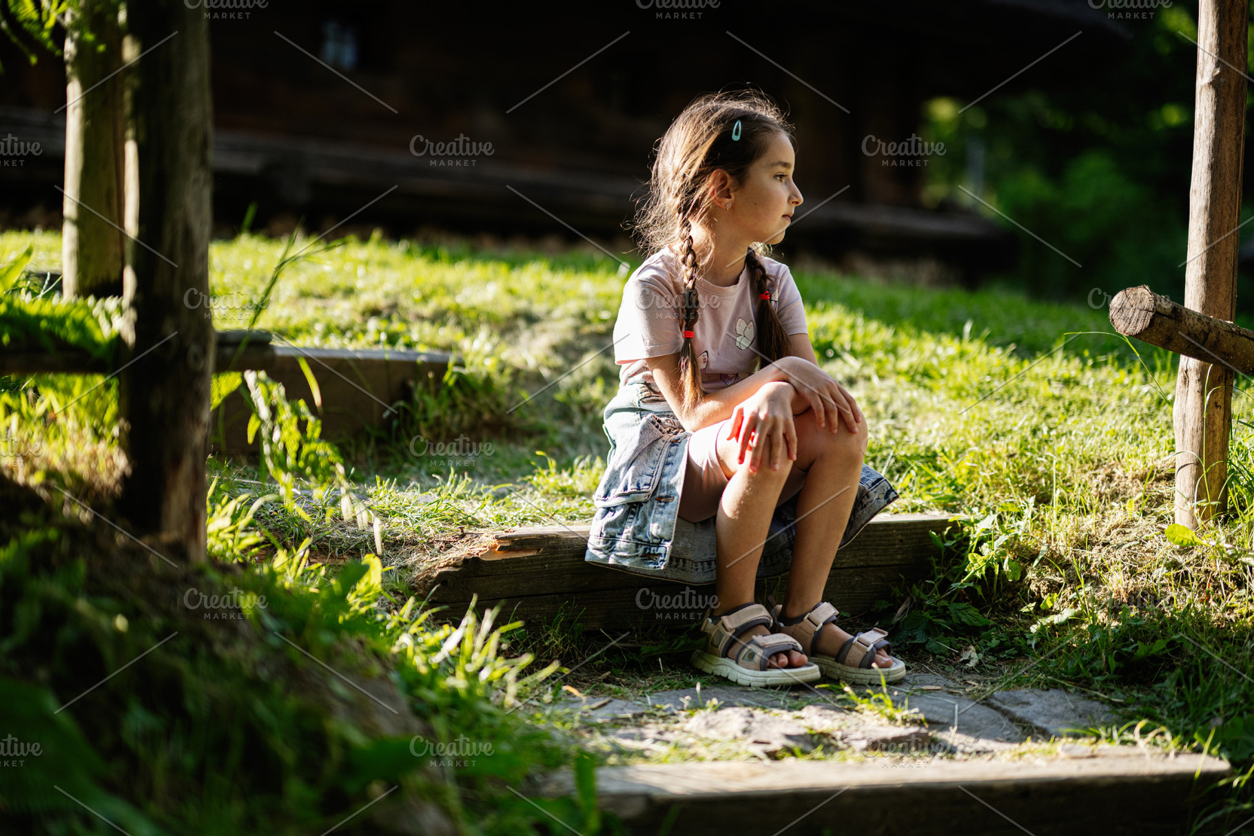 Young girl sitting on steps outdoors in a serene countryside setting, a Person Photo by AS photostudio