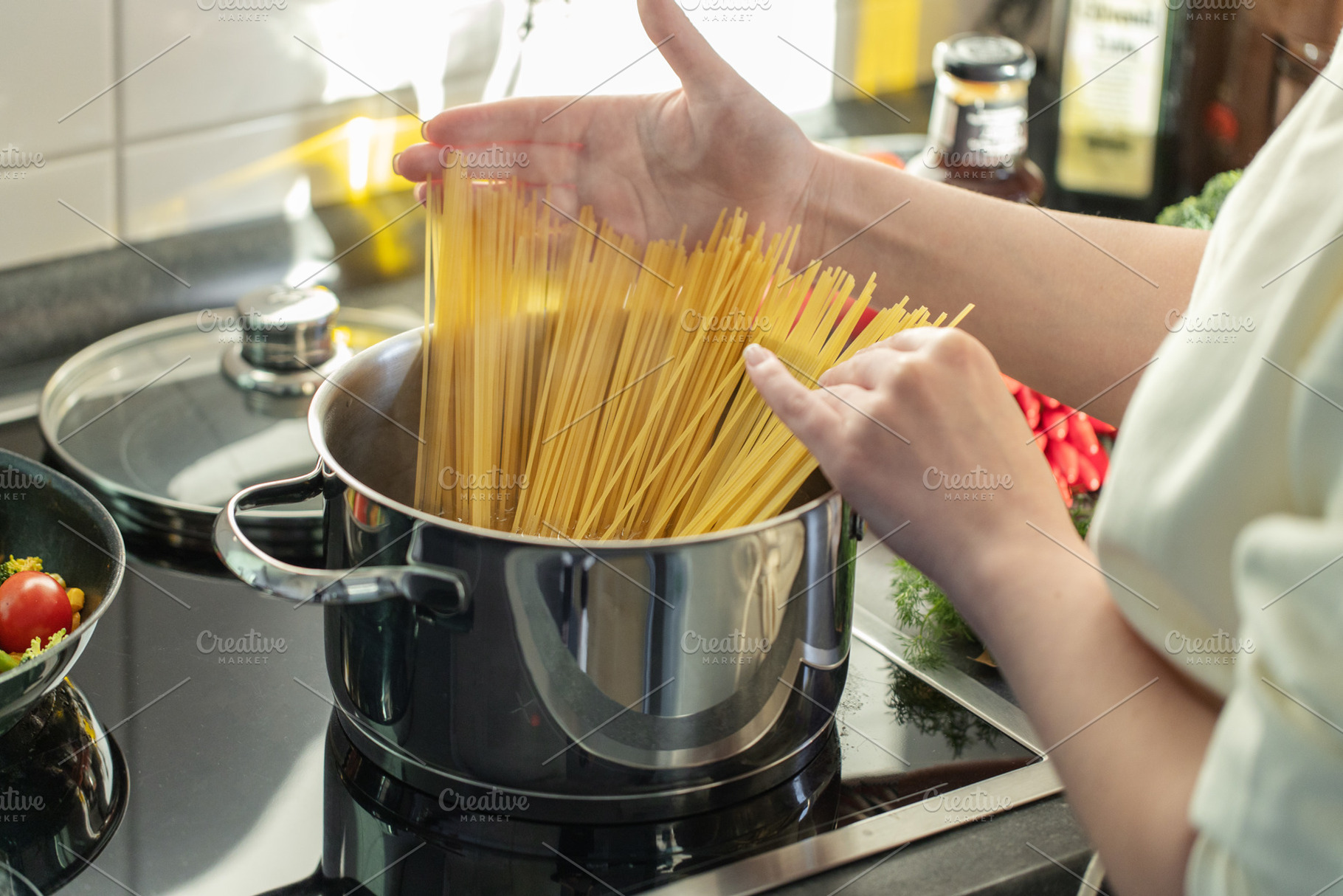 Girl cooking pasta spaghetti in pot, a Food & Drink Photo by Valeria Art