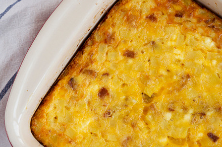 Homemade Cheesy Amish Breakfast Casserole on a white wooden surf, a Food & Drink Photo by LiudmylaChuhunova