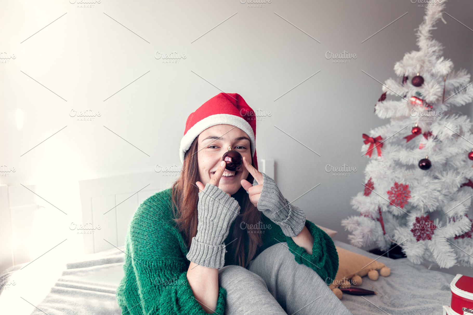 smiling girl sits on a bed against t, a Holiday Photo by Eni_fly