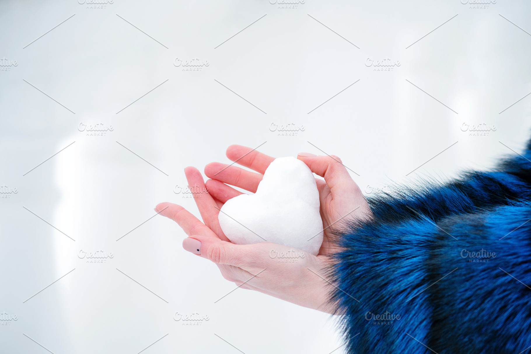 Hand Holding Snowball Heart Shape, a Holiday Photo by Elena Vagengeim