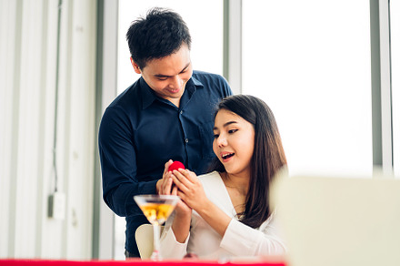 Young handsome man giving ring for surprise to girlfriend and ta, a Person Photo by Art_Photo
